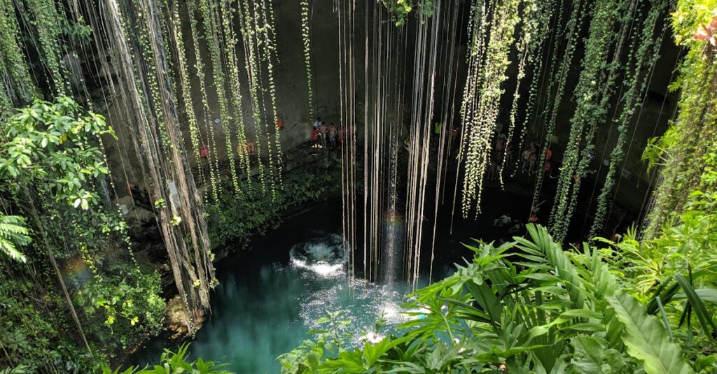 Beautiful view of Cenote Ik Kil surrounded by lush greenery in Yucatan, Mexico.