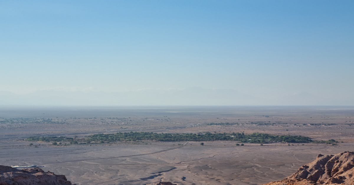Breathtaking view of the Atacama Desert showcasing its vast, arid landscape under a clear blue sky.